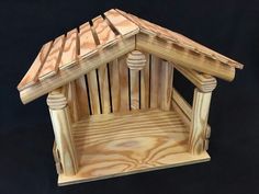 a small wooden chair with a roof made out of plywood and wood planks