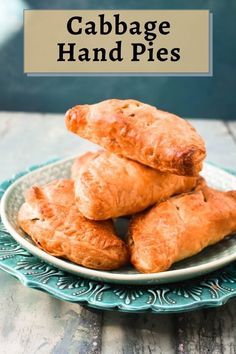 some food is stacked on top of each other in a blue and white plate with the words cabbage hand pies