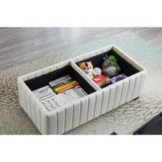 a white and black storage box on top of a rug