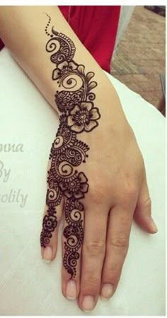 a henna tattoo on the arm of a woman