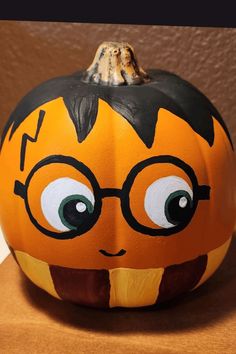 a pumpkin painted to look like a cartoon character with glasses on it's face