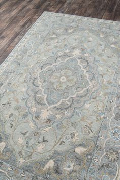 a large rug with an intricate design on the top and bottom in light blue tones