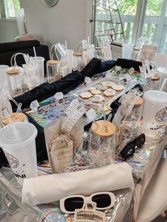 the table is set up with many items for guests to eat and drink on it