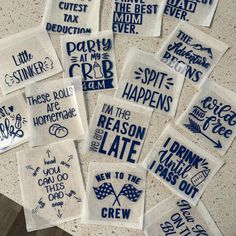 embroidered tea towels with sayings on them sitting on a countertop in front of a tile wall