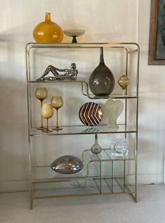 a metal shelf filled with vases and other decorative items