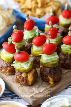 small appetizers are arranged on a cutting board