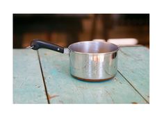 a metal pan sitting on top of a wooden table