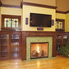 a living room with a fireplace and entertainment center