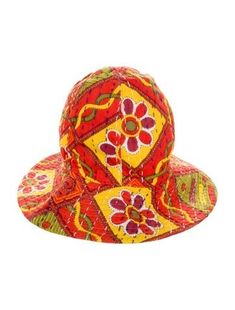 a red and yellow hat with flowers on it