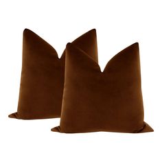 two brown pillows sitting next to each other