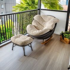 a rocking chair and ottoman on a balcony