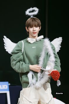 a young man is dressed up as an angel