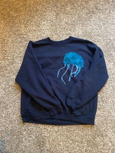 Hand sewn lettering, you can choose the color of the words and jellyfish! Art On Sweatshirt, Casual Blue Sweatshirt With Letter Embroidery, Blue Casual Sweater With Letter Embroidery, Blue Embroidered Crew Neck Hoodie, Blue Crew Neck Hoodie With Embroidered Graphics, Blue Streetwear Sweatshirt With Embroidered Text, Blue Embroidered Text Sweatshirt For Streetwear, Blue Sweatshirt With Embroidered Text For Streetwear, Sewed Sweatshirt