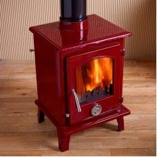 a red stove sitting on top of a wooden floor