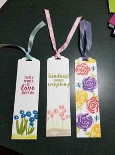 three bookmarks with different designs on them sitting on a table next to each other