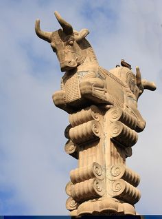 the statue is made of stone and has horns on it