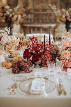 the table is set with flowers, candles and other items for an elegant wedding reception