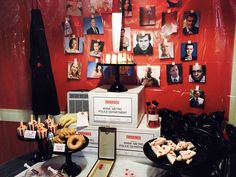 a table topped with donuts and pictures on the wall