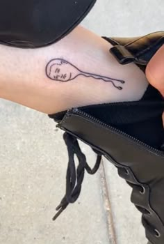 a woman's foot with a tattoo on it