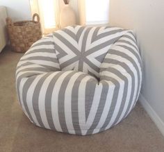 a grey and white bean bag chair sitting on the floor