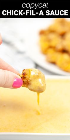 a person dipping some kind of food into sauce