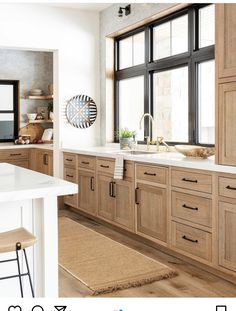 an instagram page on the iphone shows a kitchen with wooden cabinets and white counter tops