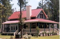 a house with a red metal roof and porch