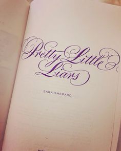 an open book with purple writing on it and the words wedding little lions written in cursive ink