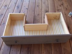 a wooden box sitting on top of a wooden floor