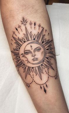 a sun and moon tattoo on the arm