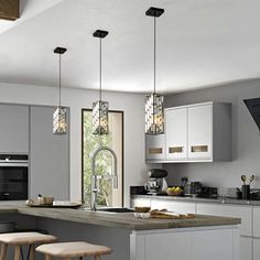 a modern kitchen with an island and stools