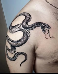 a man's chest with a snake tattoo on his arm and the other side