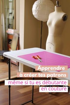 a mannequin is standing next to a table with scissors on it and the words apprendre a creer les patrons meme si tus de debate en couture