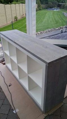 a white bookcase sitting on top of a sidewalk