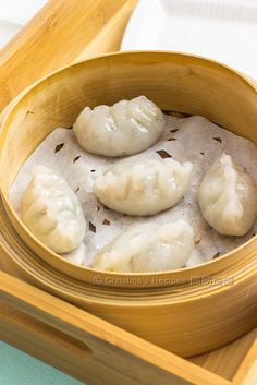 some dumplings are sitting in a wooden bowl