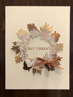 a card with some leaves on it and the words hey there