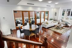 a living room filled with furniture and wooden floors