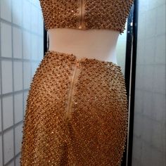 a dress made out of gold sequins