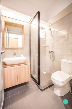 a bathroom with a toilet, sink and shower in it's own stall area