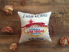 a pillow with the las vegas sign on it and rose petals around it that reads, cruise & christ welcome to fabulous las vegas nevada