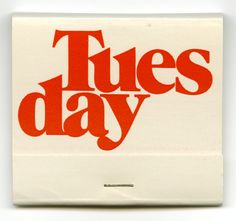 a white and red tile with the words tuesday written in bold red letters on it