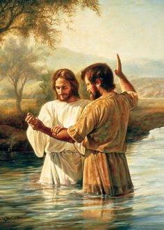 two men standing in the water with one pointing at another man's head and holding his hand up