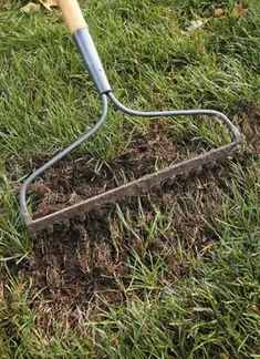 a shovel is stuck in the ground with grass