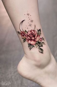 a woman's foot with roses and stars on the side of her leg, which is