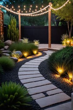 an outdoor walkway with lights and plants on the sides, surrounded by graveled stones