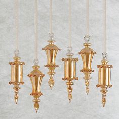 gold colored glass chandeliers hanging from strings