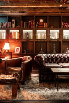 a living room filled with lots of furniture and bookshelves next to each other