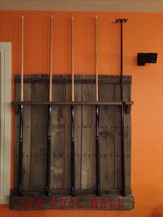 an old wooden rack with baseball bats hanging from it