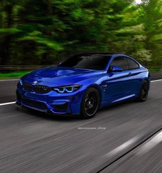 a blue bmw is driving down the road