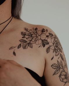 a woman's shoulder with flowers on it